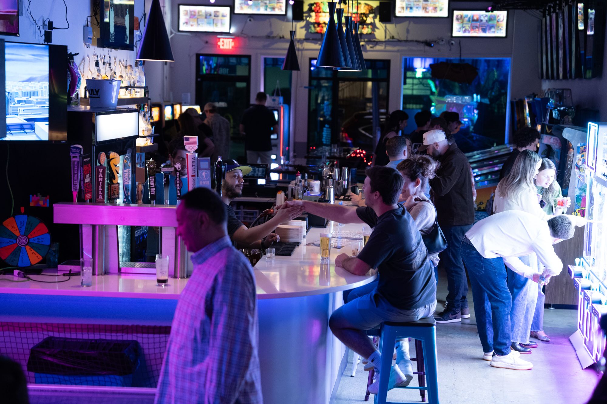 Pinball machines and neon atmosphere at Super Rad arcade bar Raleigh