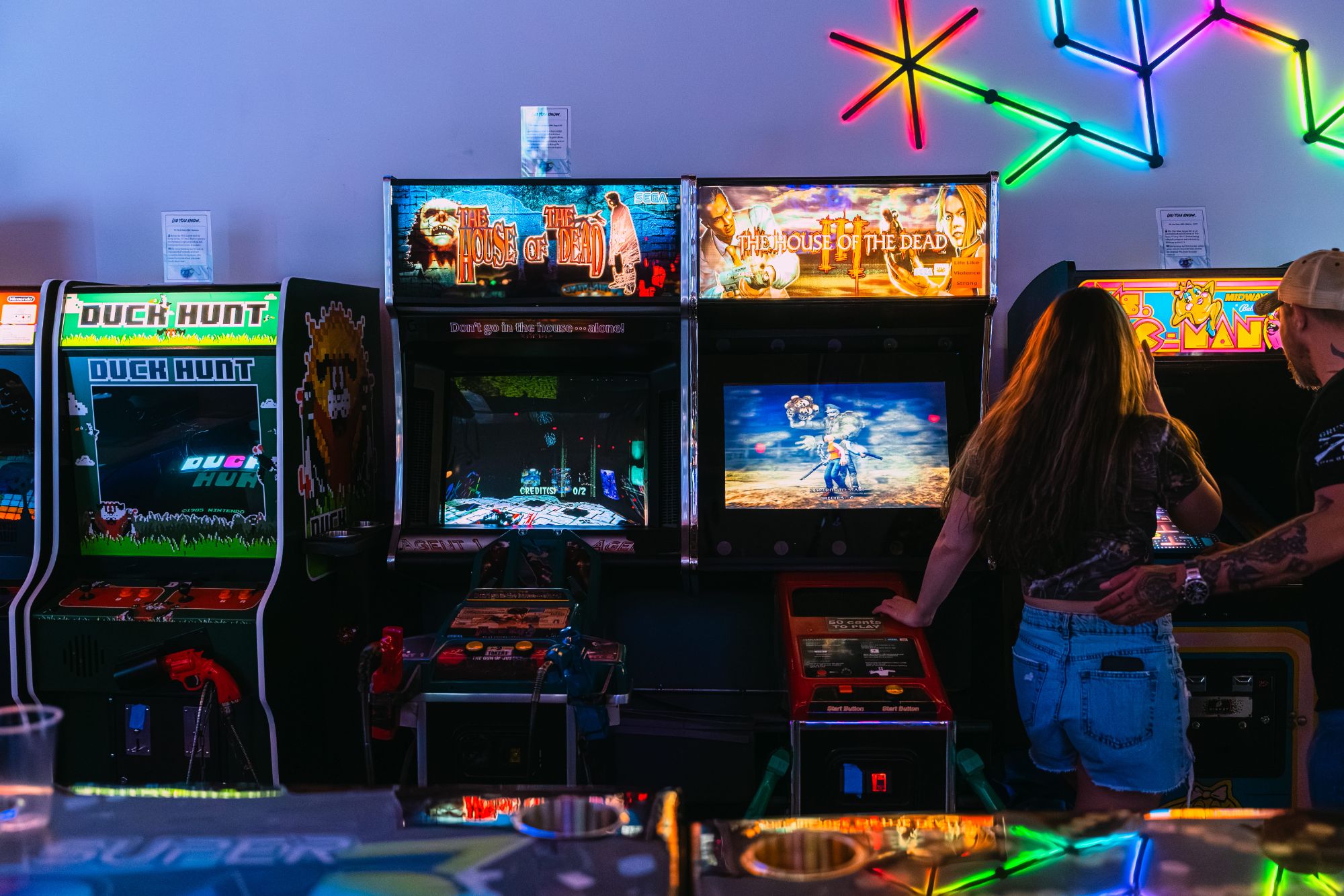 Classic arcade cabinets with neon lights at Super Rad Raleigh NC