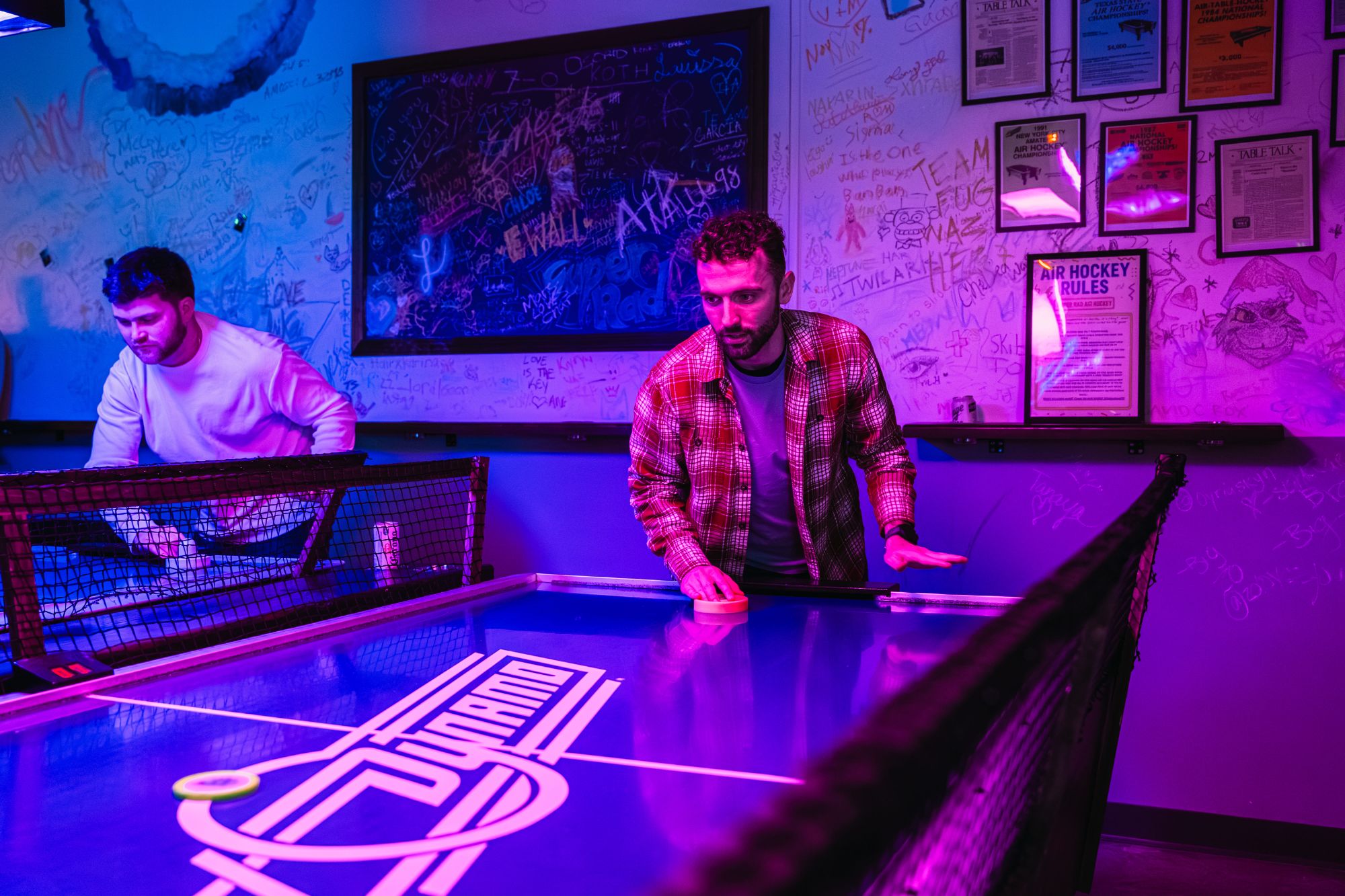 Neon-lit arcade bar interior at Super Rad Retro Lounge in Raleigh NC