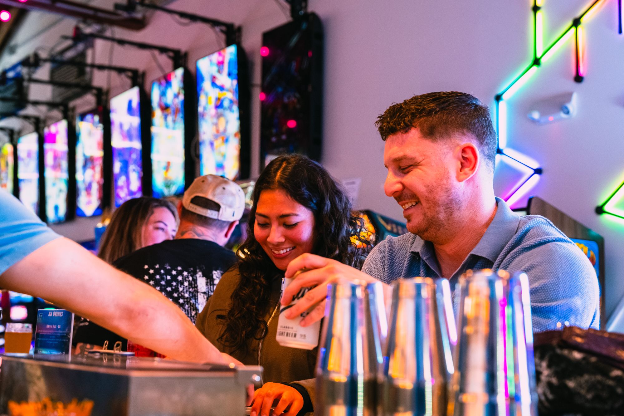 Friends enjoying drinks at the bar at Super Rad Retro Lounge
