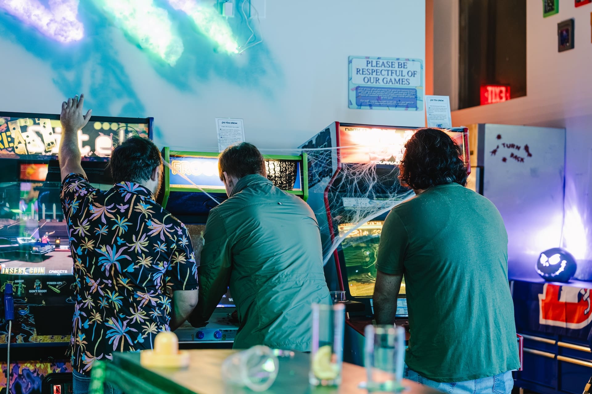 Friends cheering at the arcade games at Super Rad Raleigh