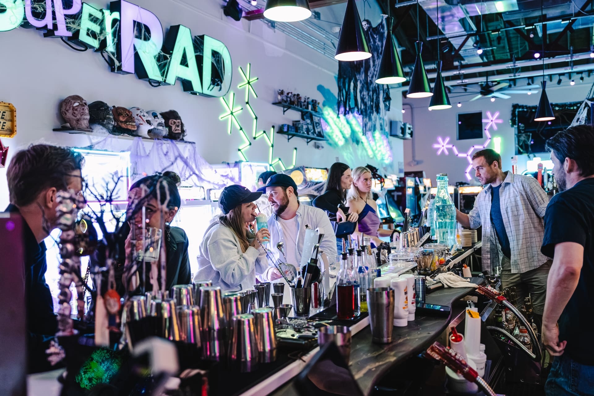 Busy happy hour crowd at the bar at Super Rad arcade bar downtown Raleigh