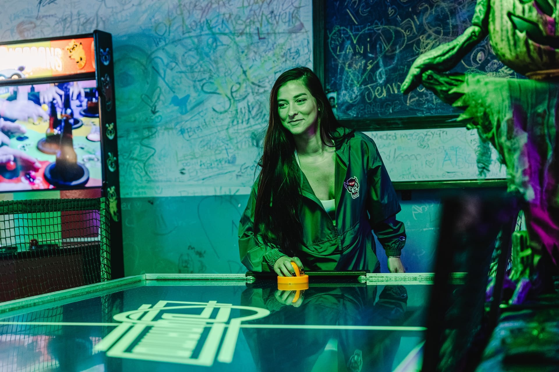 Playing air hockey on a date night at Super Rad arcade bar Raleigh NC