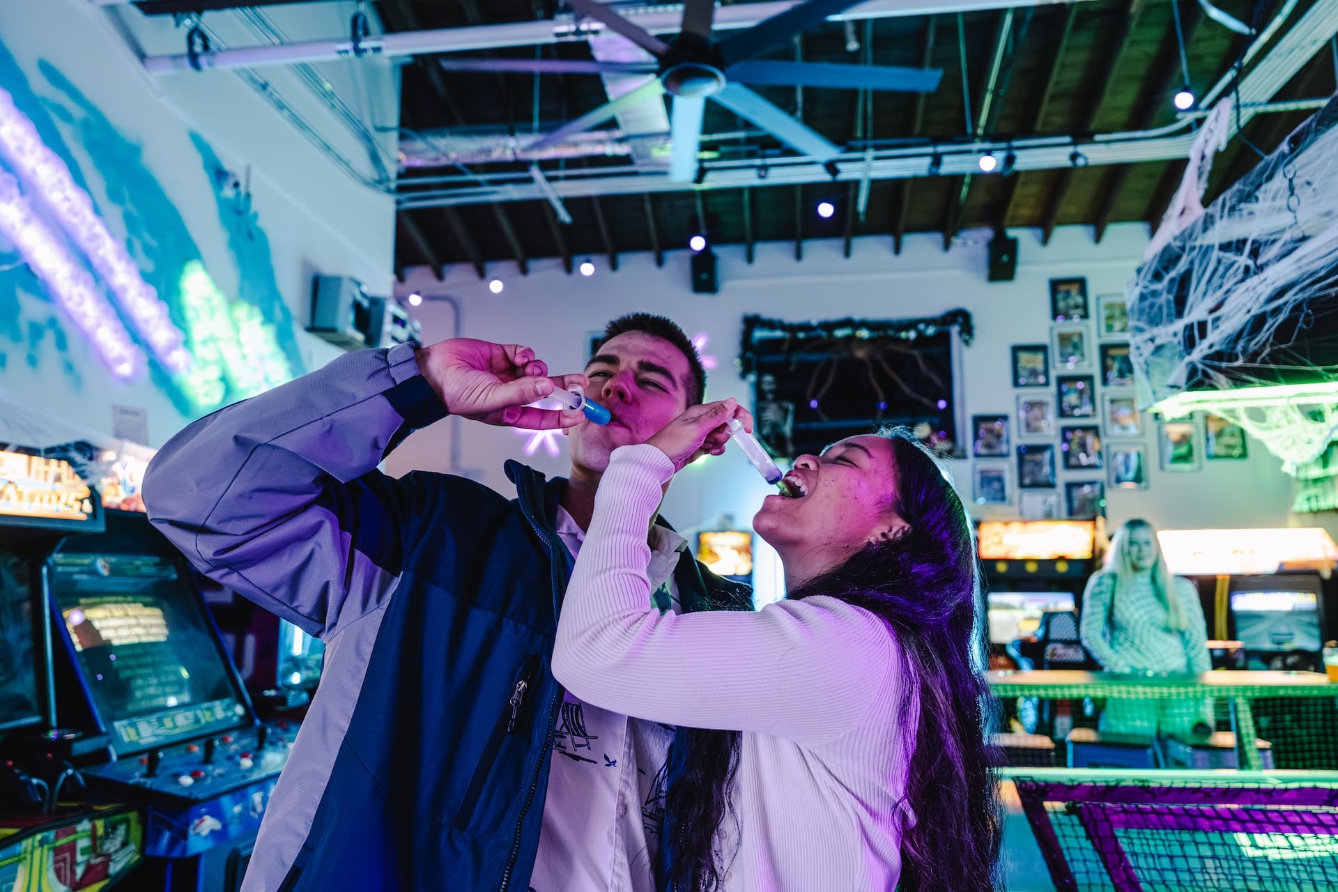 Couple sharing a drink at Super Rad Raleigh arcade bar