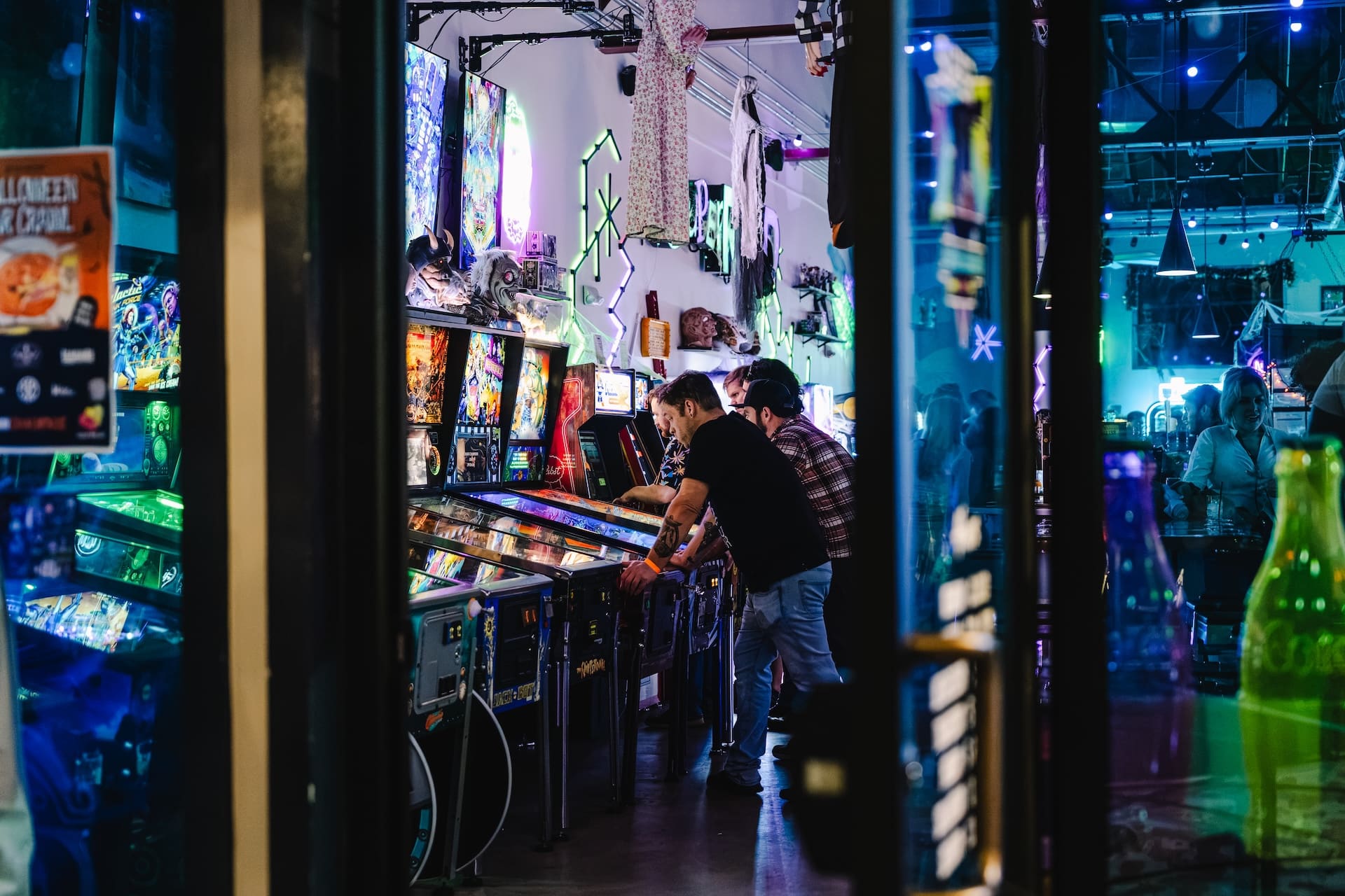 Guests playing pinball at Super Rad Raleigh arcade bar