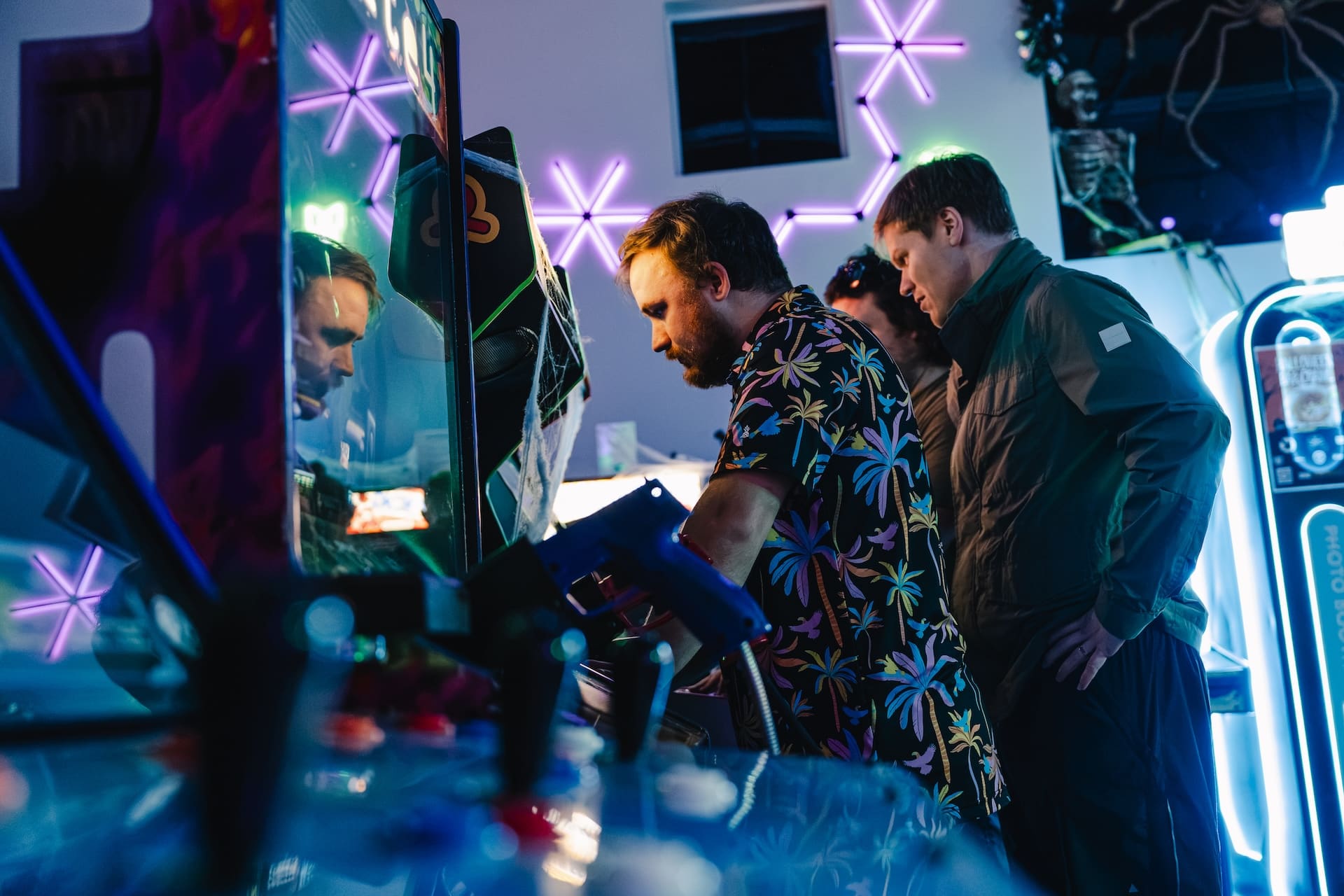 Coworkers competing on a classic arcade game at Super Rad Raleigh